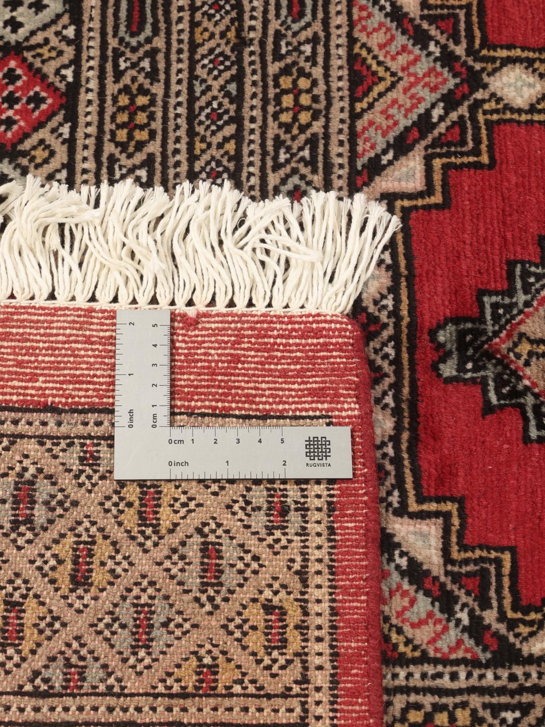 Hand-knotted Pakistan Bokhara 2ply rug in red with traditional geometric motifs