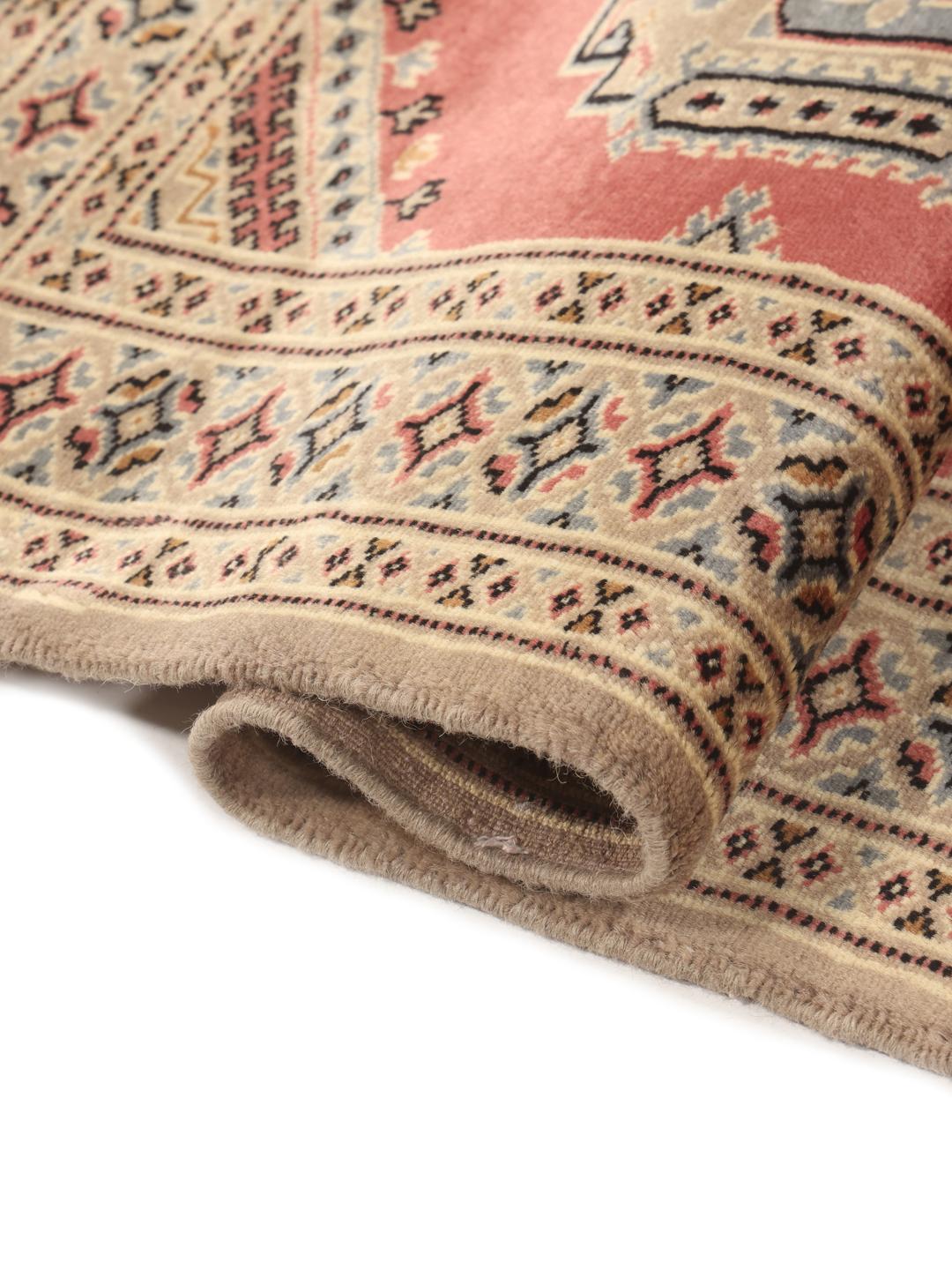 Hand-knotted Pakistan Bokhara rug with a red field and traditional medallion patterns.