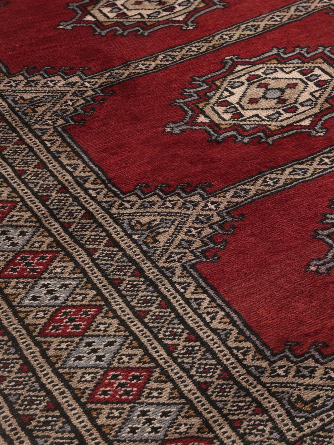 Hand-knotted red Pakistan Bokhara 2ply wool rug with medallion motifs