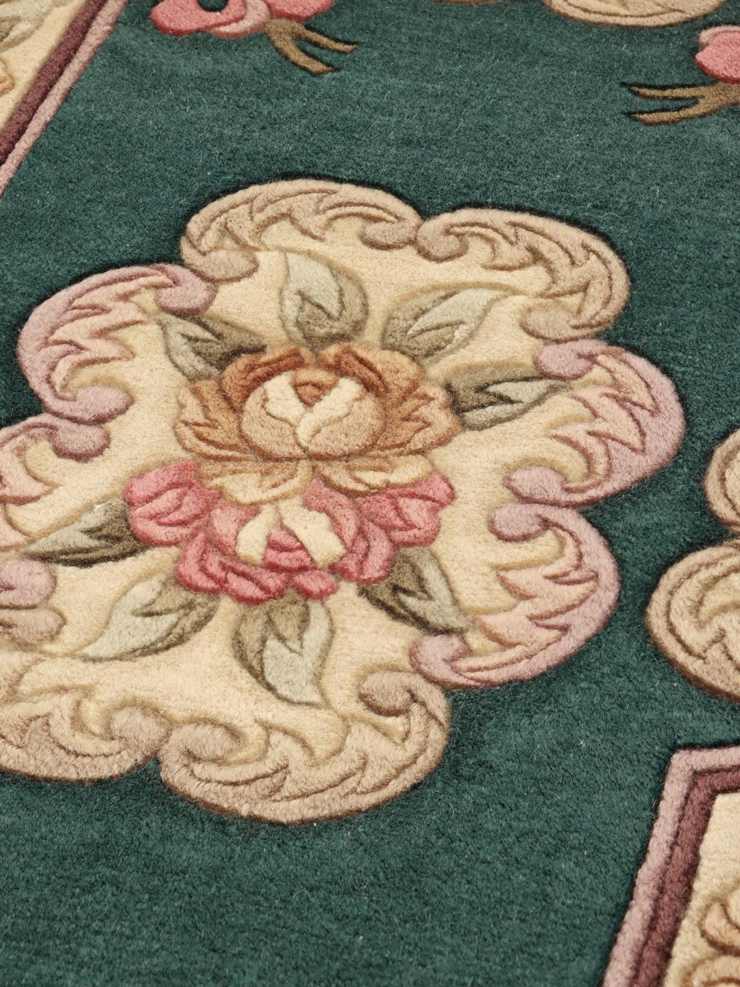 Håndknyttet kinesisk tæppe med blomstermotiver på en blågrøn baggrund