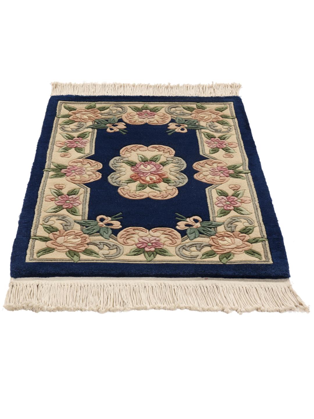 Hand-knotted floral rug from China with a deep blue background