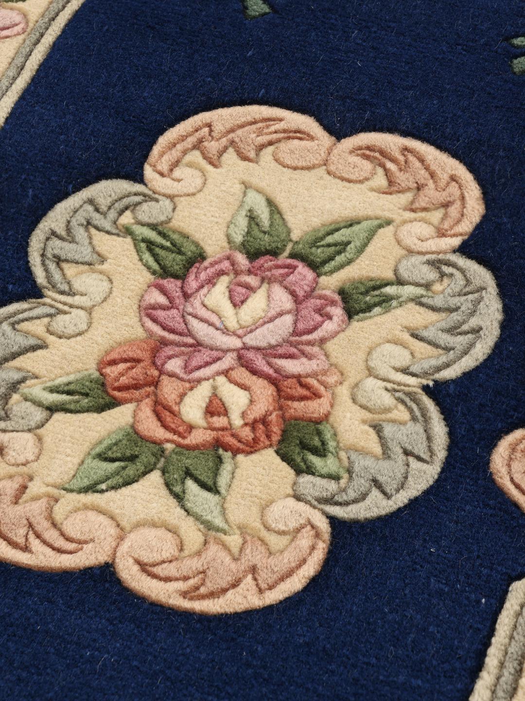 Hand-knotted floral rug from China with a deep blue background