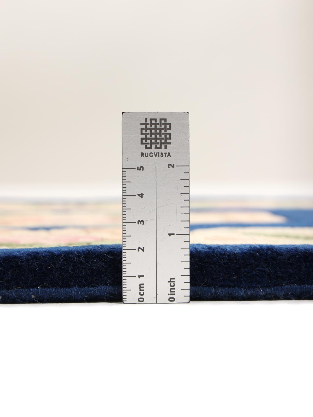 Hand-knotted floral rug from China with a deep blue background