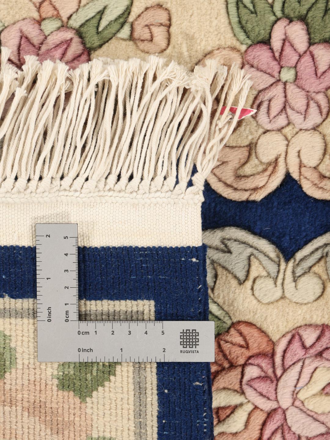 Hand-knotted floral rug from China with a deep blue background