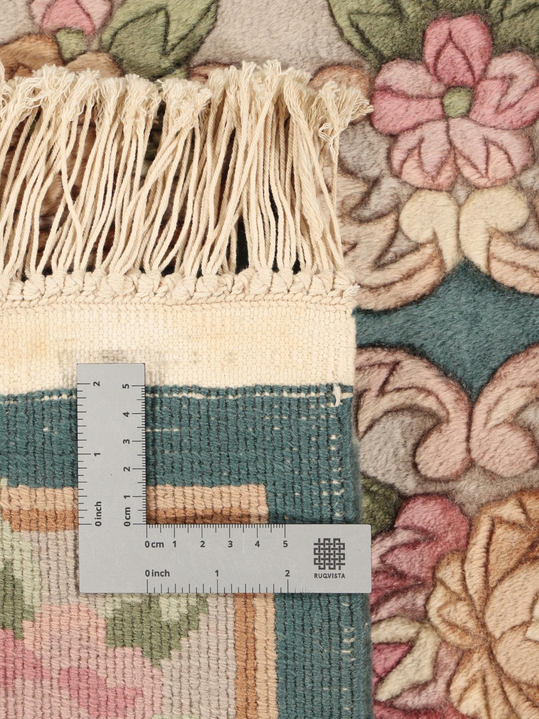 Håndknyttet kinesisk tæppe med blomstermotiver i teal, pink og beige