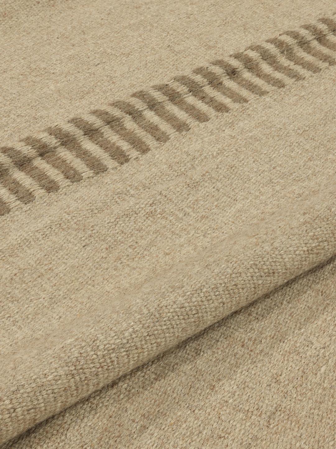 Beige tapijt met eenvoudige geweven textuur