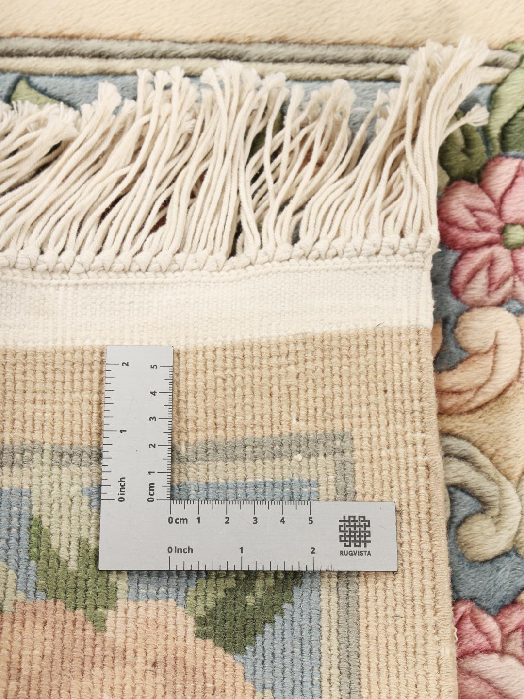Hand-knotted floral rug from China in beige and soft blue tones