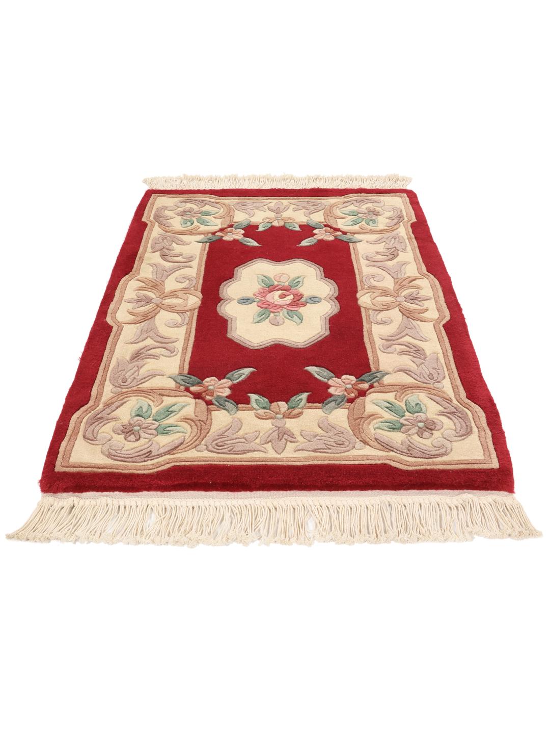 Hand-knotted rug from China with a red background and floral patterns