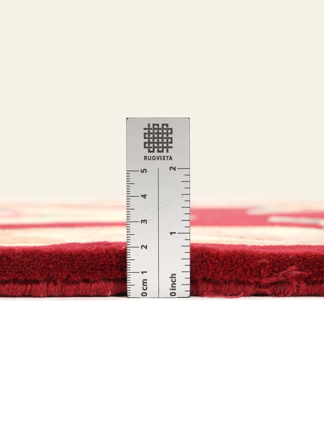 Hand-knotted rug from China with a red background and floral patterns