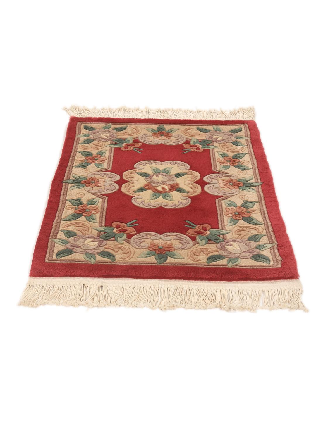 A unique rectangular hand-knotted rug from China with a red field and floral patterns.