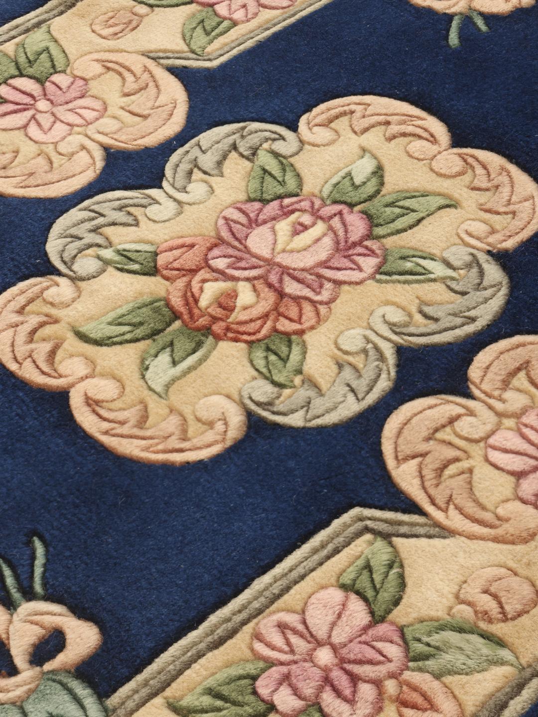 Hand-knotted Chinese rug featuring a floral pattern on a deep blue background