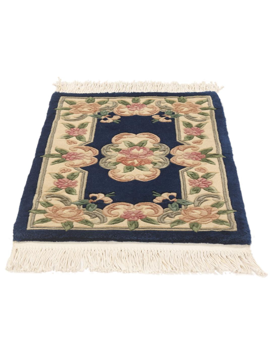 A rectangular hand-knotted rug from China featuring a blue field and floral pattern.