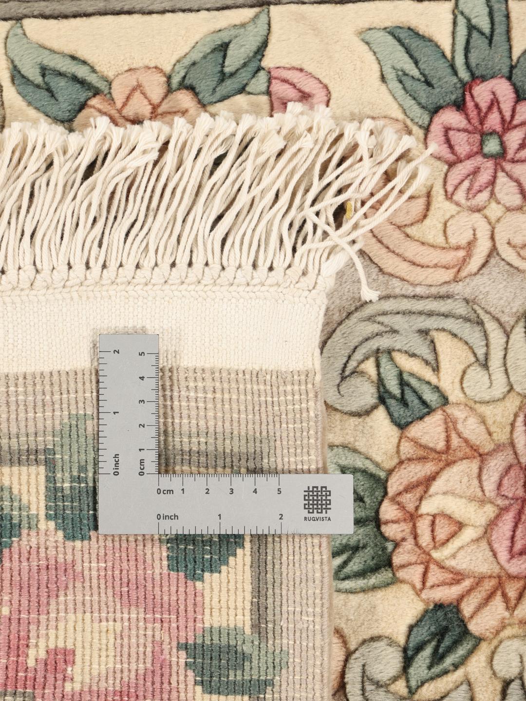 Hand-knotted Chinese rug with floral motifs in beige, pink, and green
