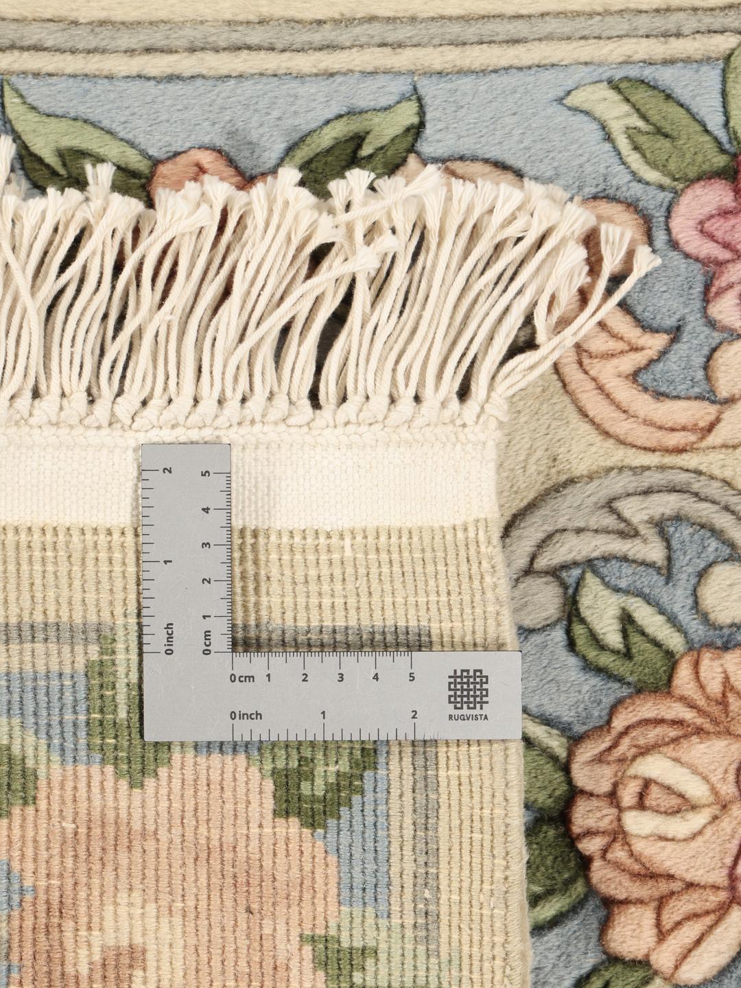 Håndknyttet kinesisk tæppe med et delikat blomsterdesign i bløde pastelfarver