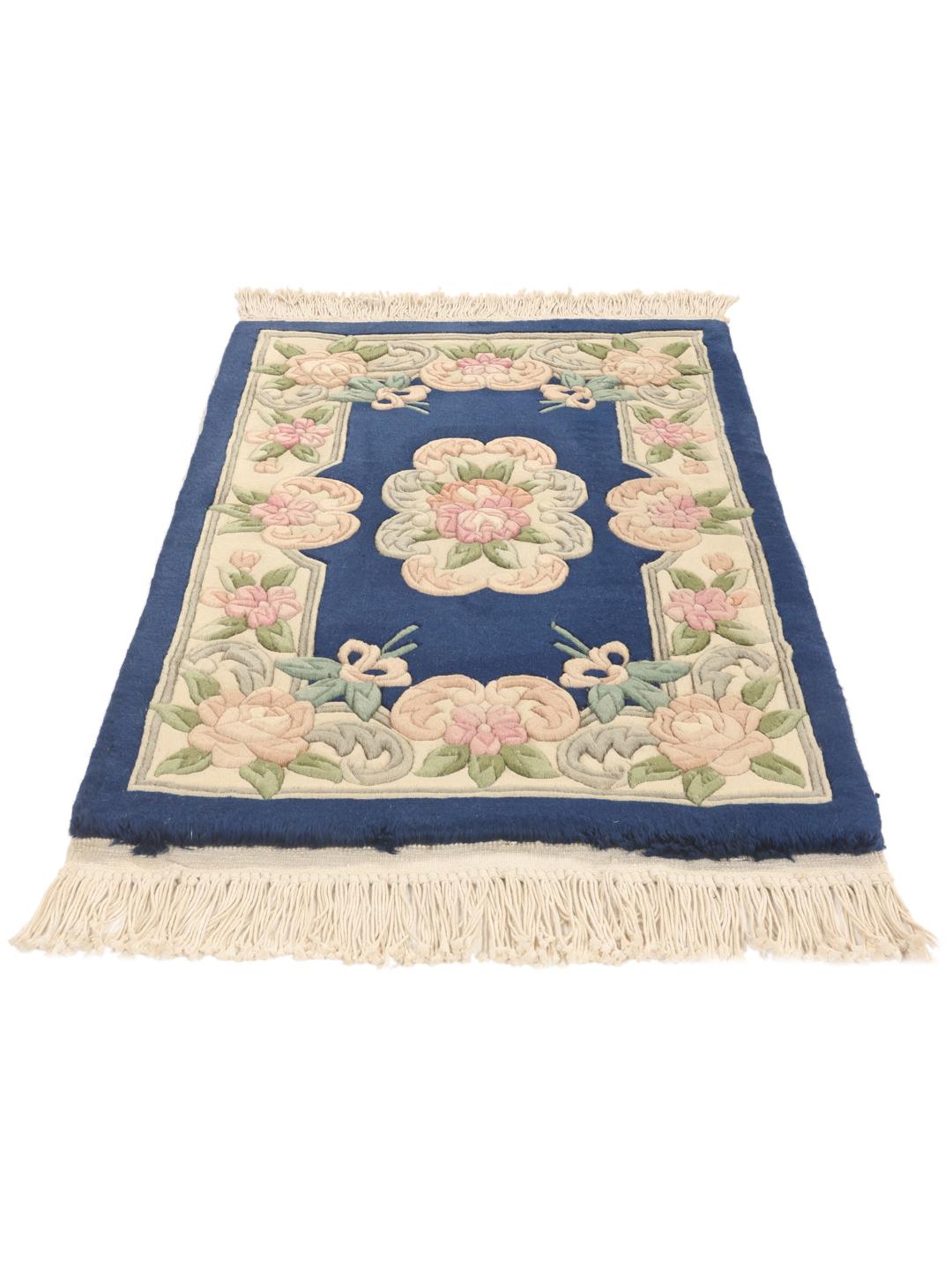 Hand-knotted Chinese rug with floral motifs on a deep blue background