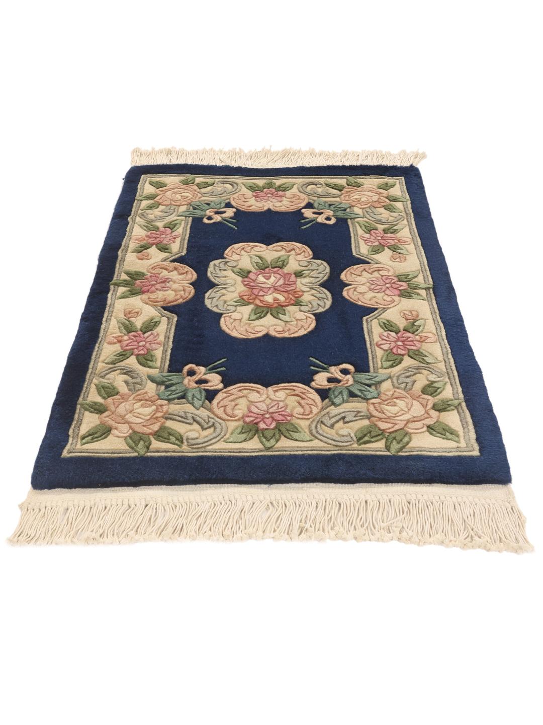 Hand-knotted Chinese rug with floral motifs on a deep blue background