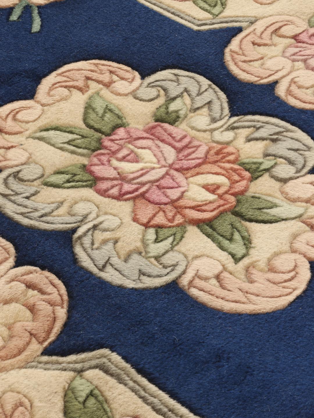 Hand-knotted Chinese rug with floral motifs on a deep blue background