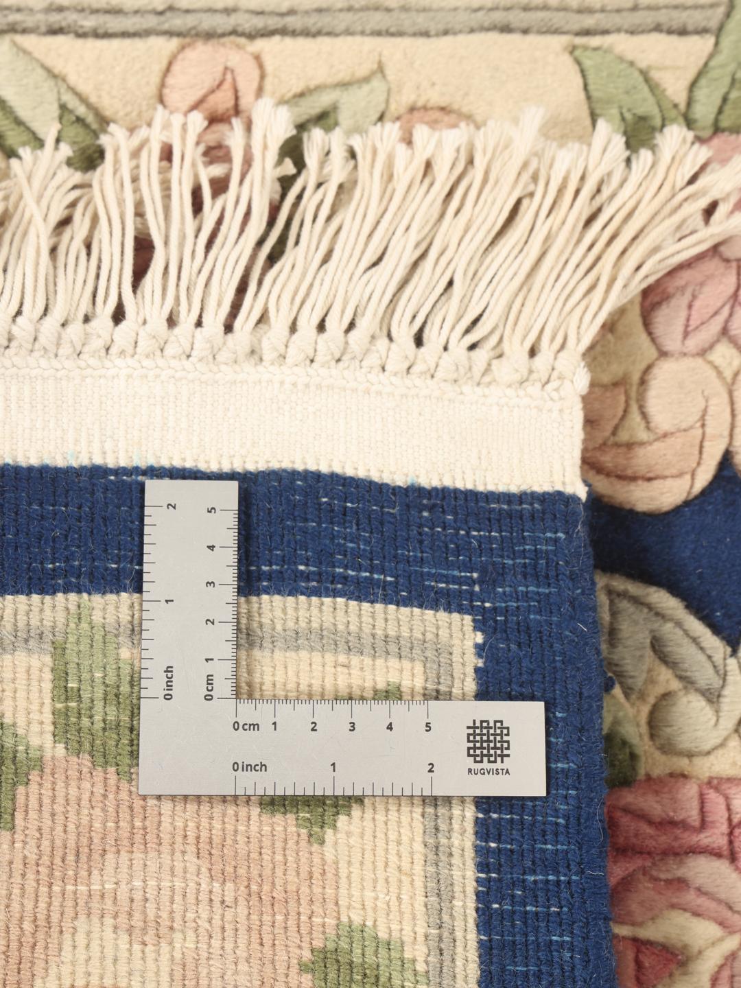 Hand-knotted Chinese rug with floral motifs on a deep blue background
