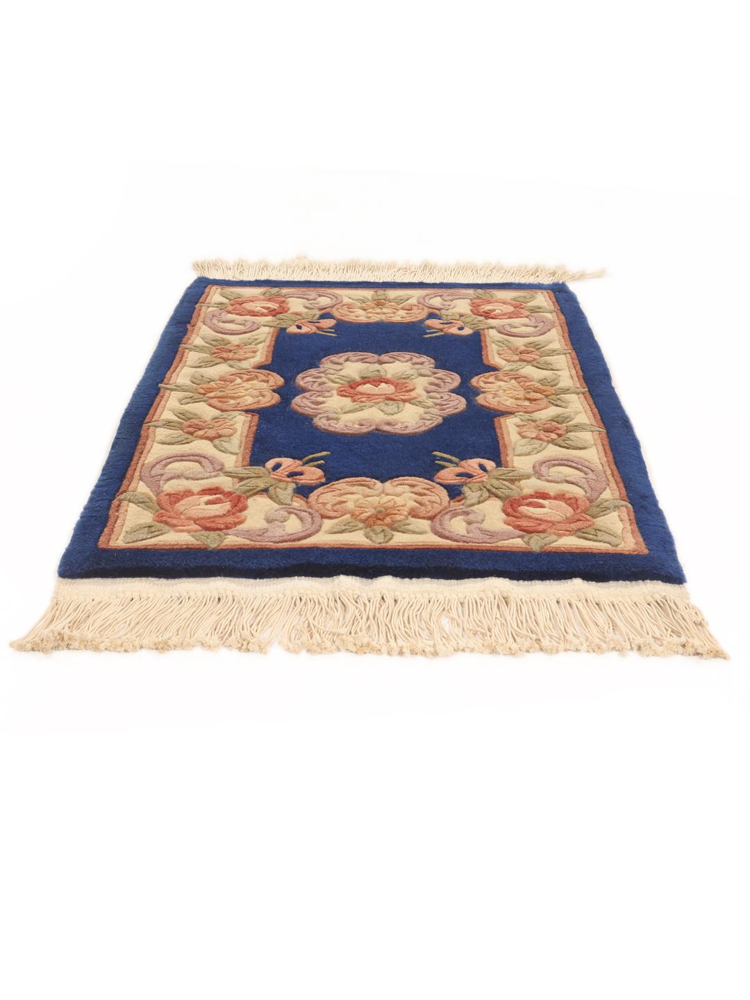 A rectangular hand-knotted rug from China with a blue field and floral pattern.