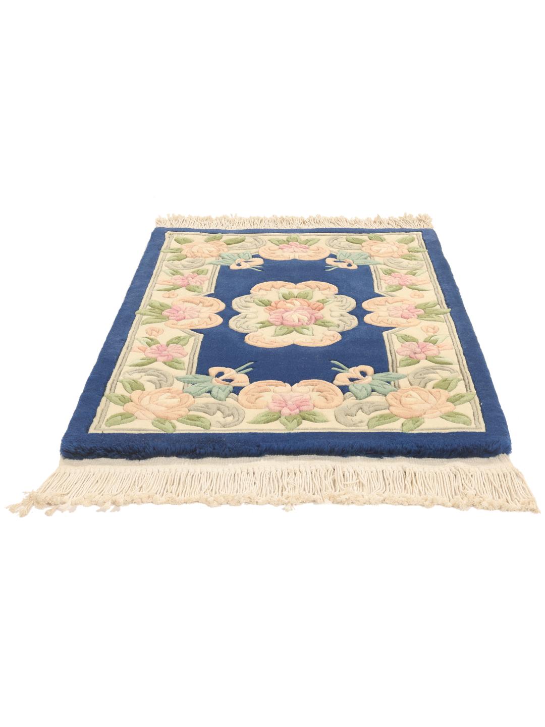 Hand-knotted Chinese rug with floral motifs in blue and soft pastel tones.