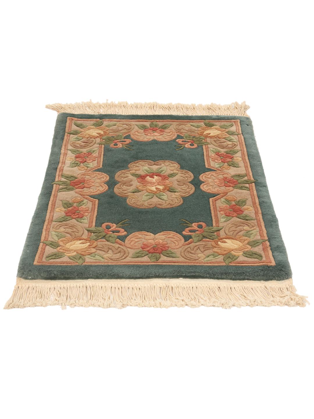 A small, one-of-a-kind Chinese hand-knotted rug with a teal background and floral patterns.