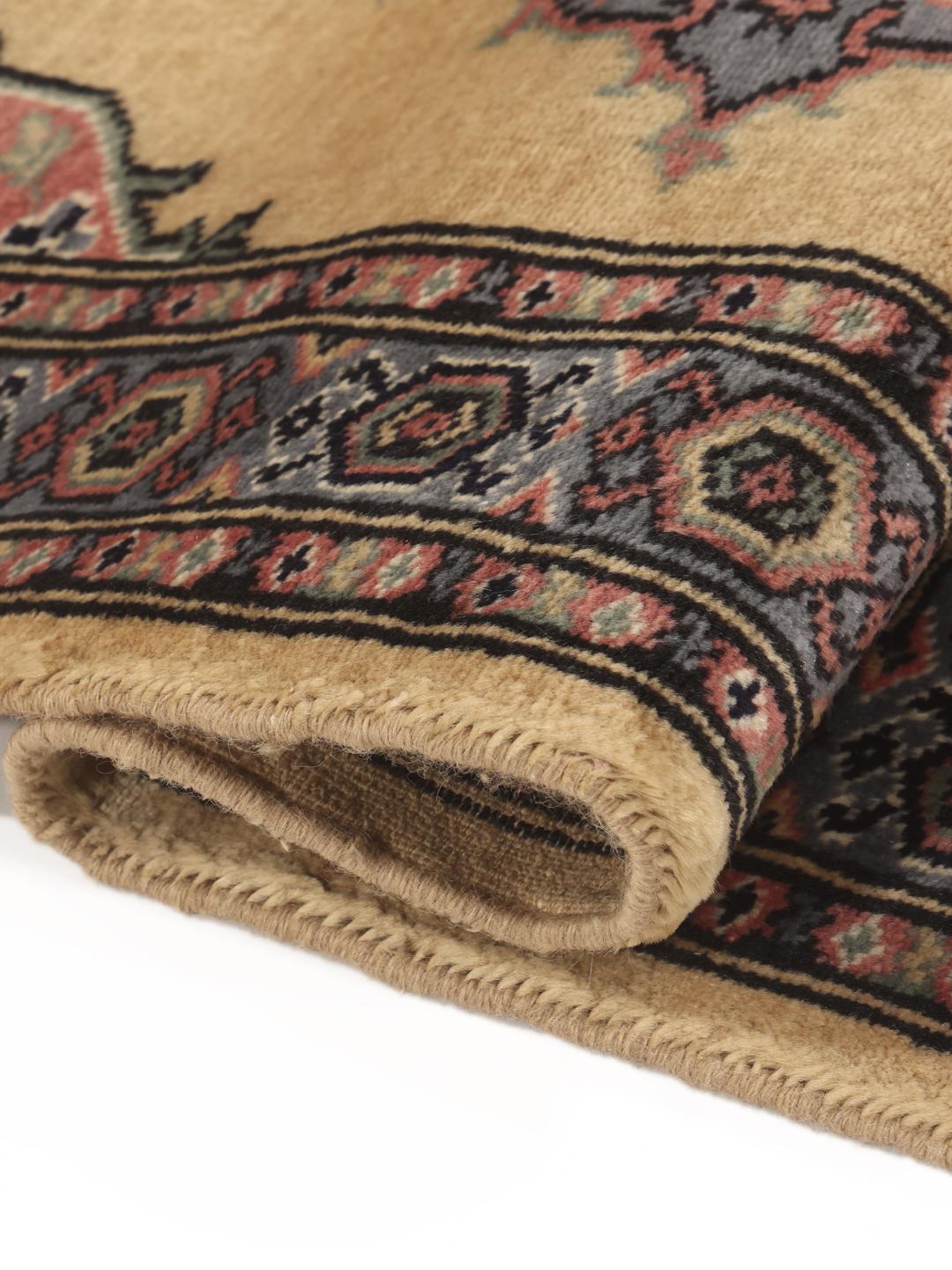 Hand-knotted Pakistan Bokhara rug with a beige field and medallion pattern