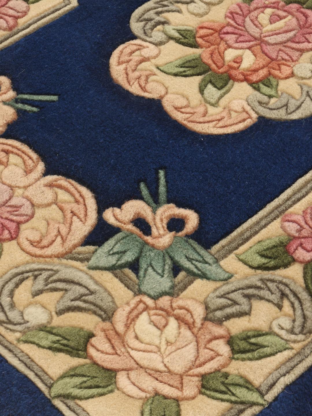 Hand-knotted Chinese rug with floral motifs on a deep blue background