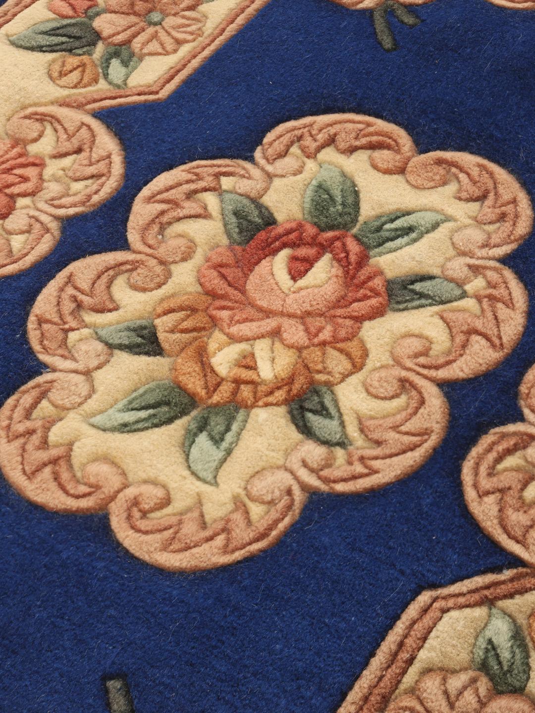 Hand-knotted Chinese rug with a floral pattern on a blue background