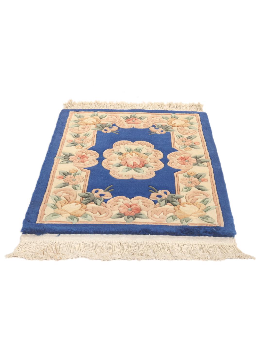 Hand-knotted Chinese rug with a floral pattern on a blue background