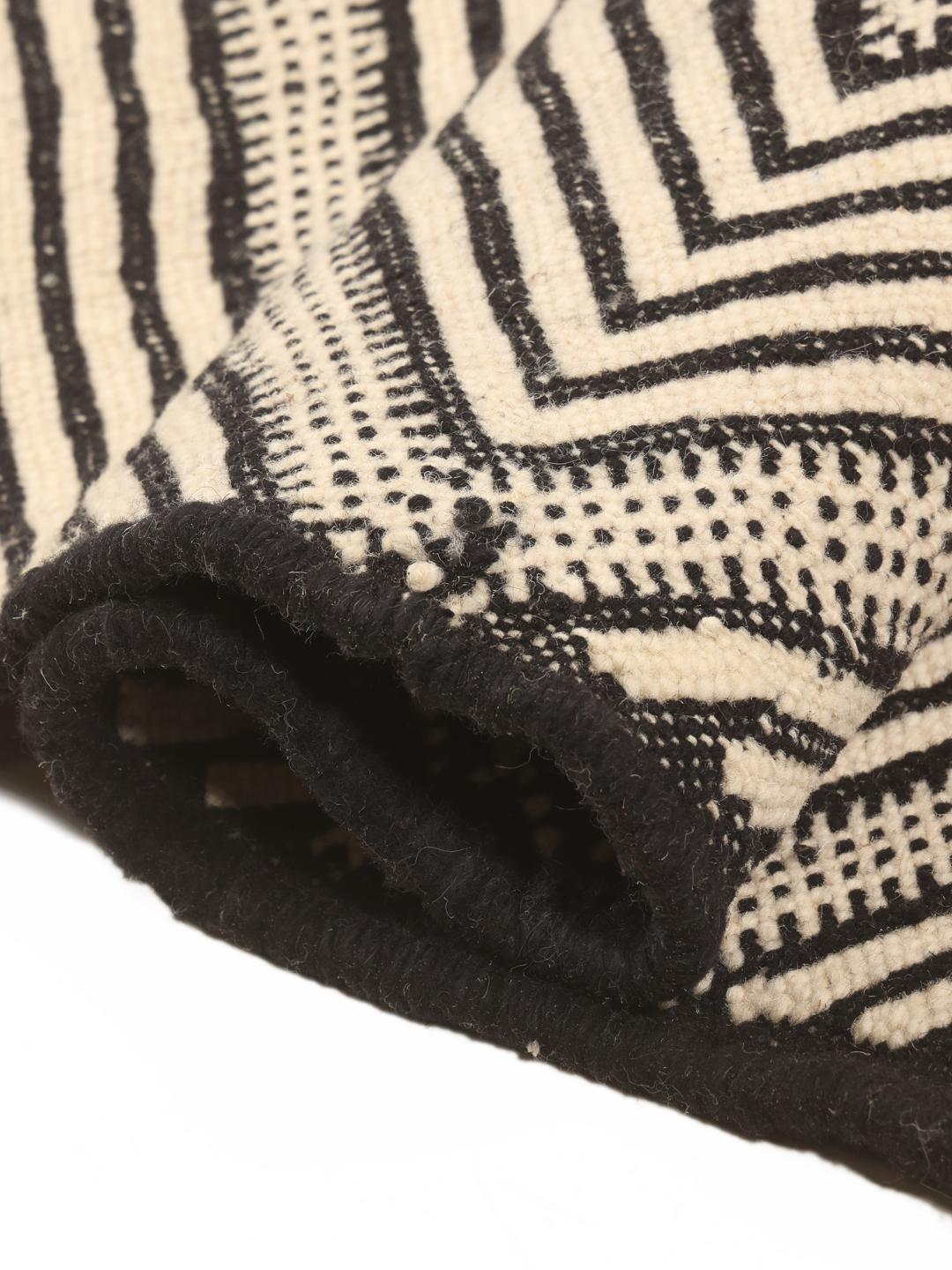 Hand-woven Moroccan High Atlas Kelim rug with a geometric diamond pattern in beige and black