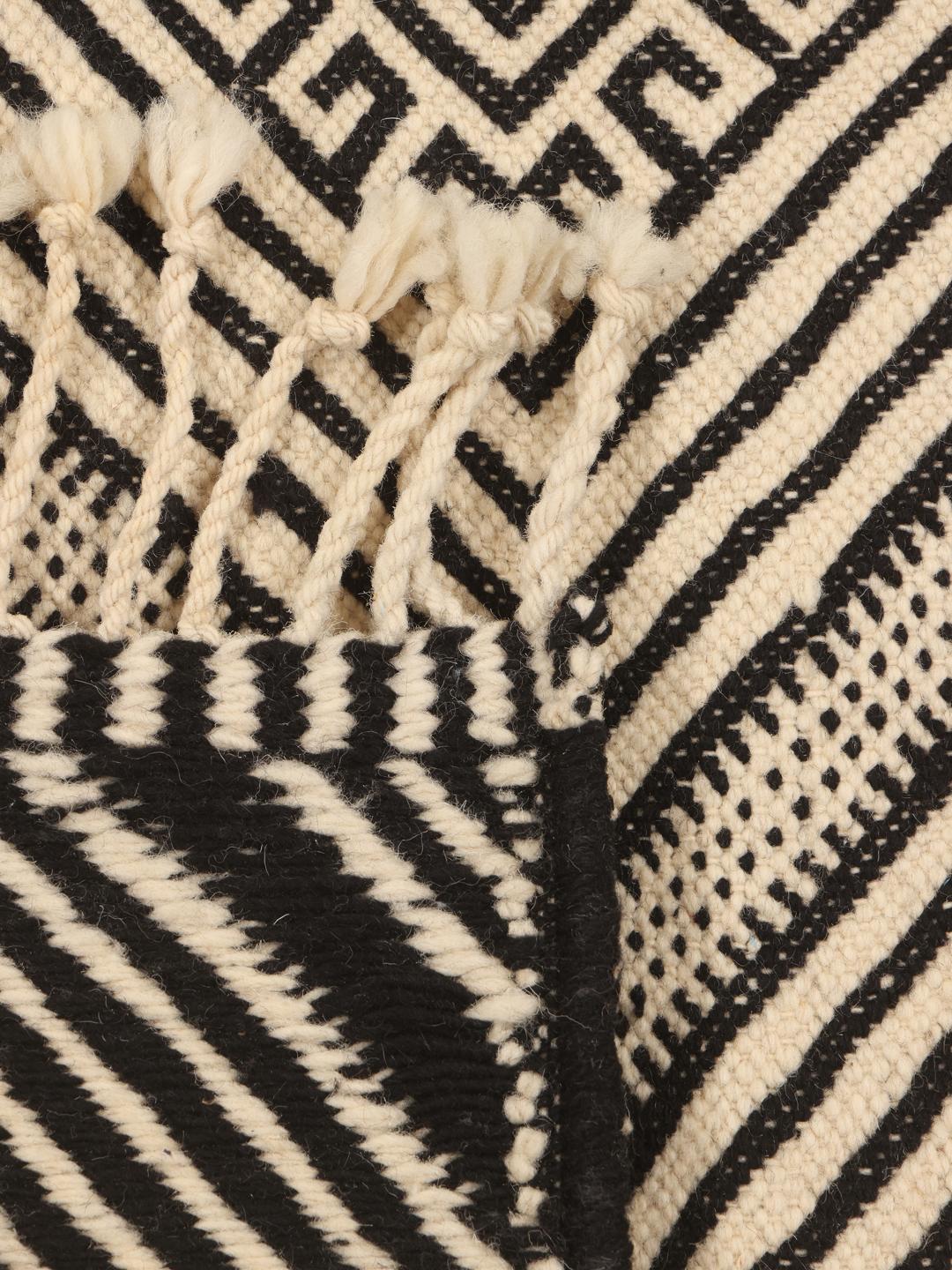 Hand-woven Moroccan High Atlas Kelim rug with a geometric diamond pattern in beige and black