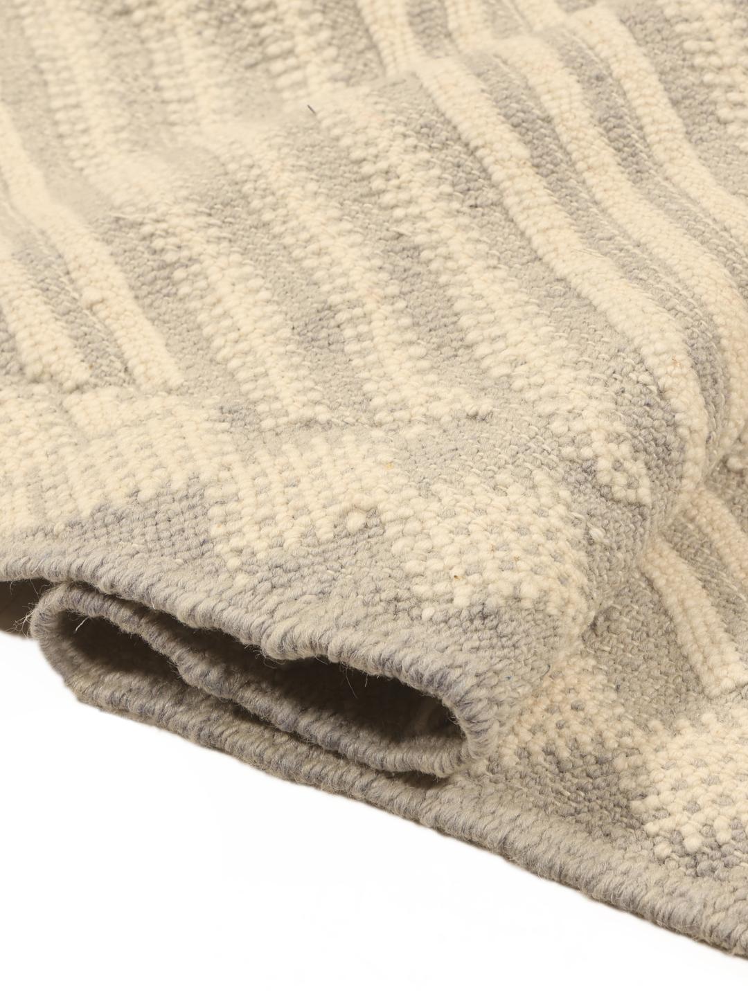 Hand-woven Moroccan rug with diamond patterns in beige and grey