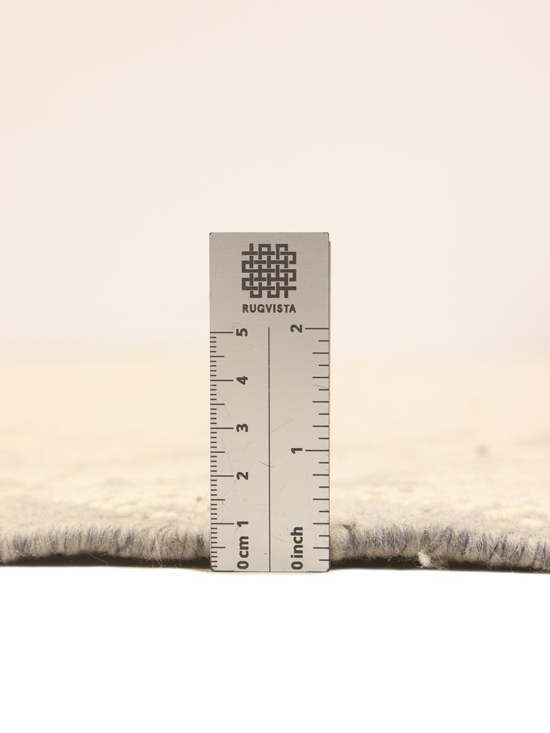 Hand-woven Moroccan rug with diamond patterns in beige and grey