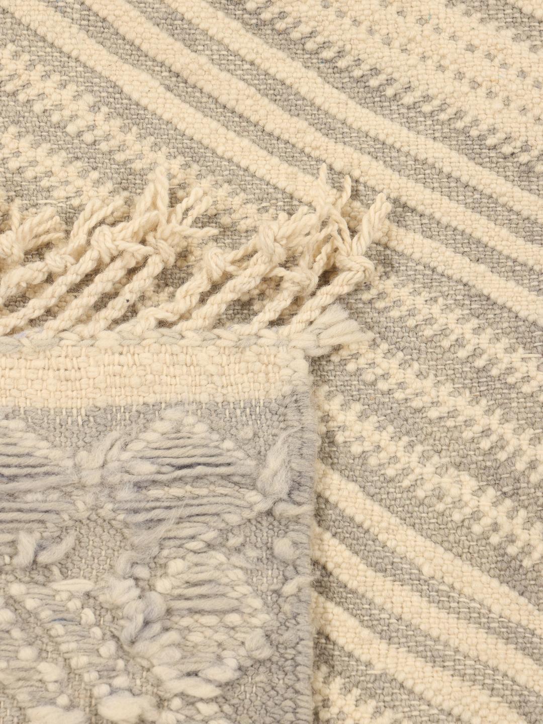 Hand-woven Moroccan rug with diamond patterns in beige and grey