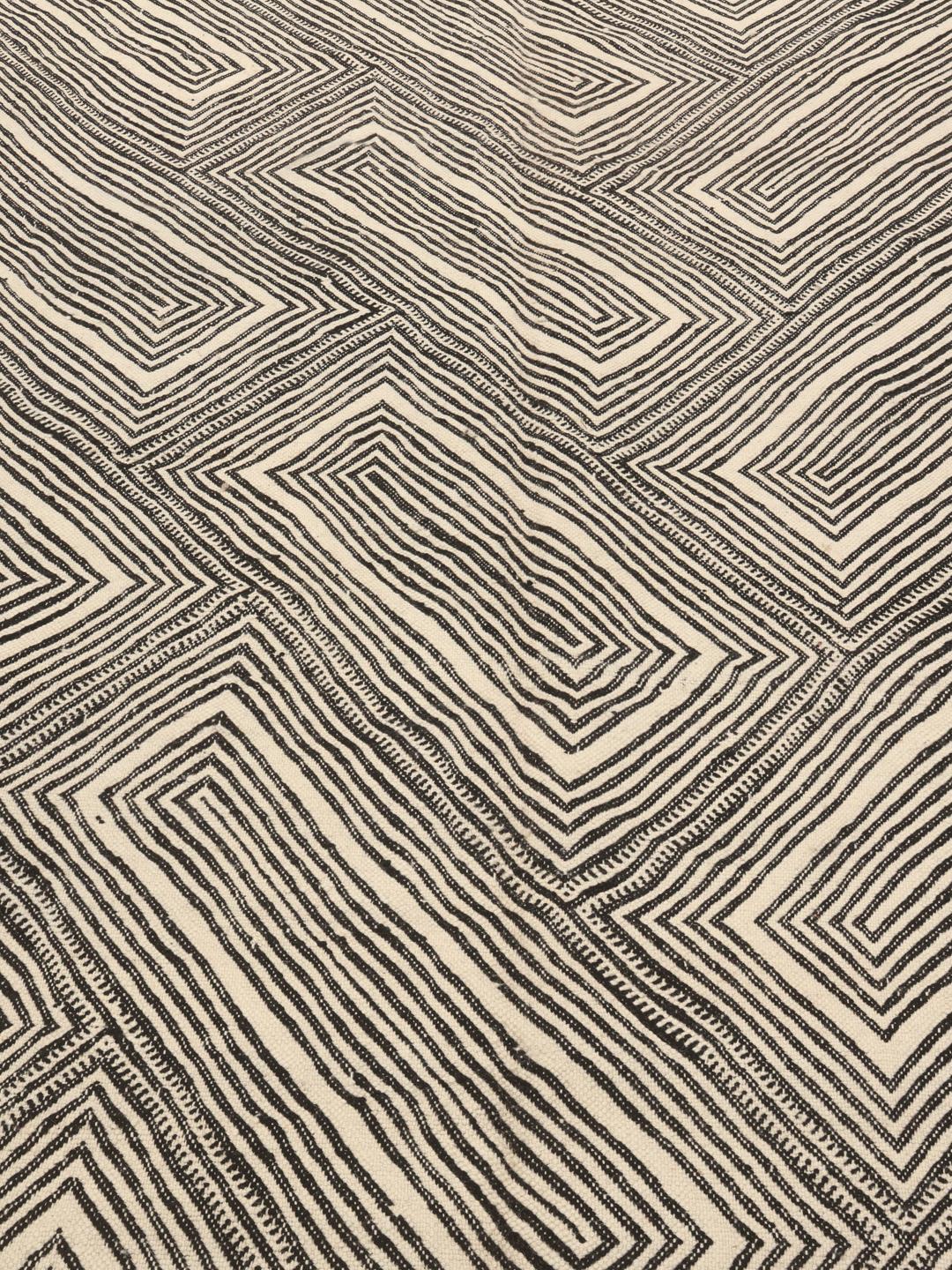 Hand-woven Moroccan High Atlas rug with geometric black and off-white patterns.