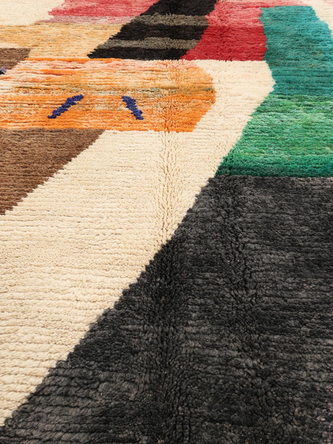 A vibrant, abstract, hand-knotted Berber Beni Ourain rug from Morocco in multicolor.