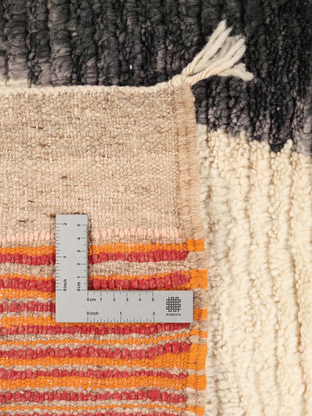 A vibrant, abstract, hand-knotted Berber Beni Ourain rug from Morocco in multicolor.
