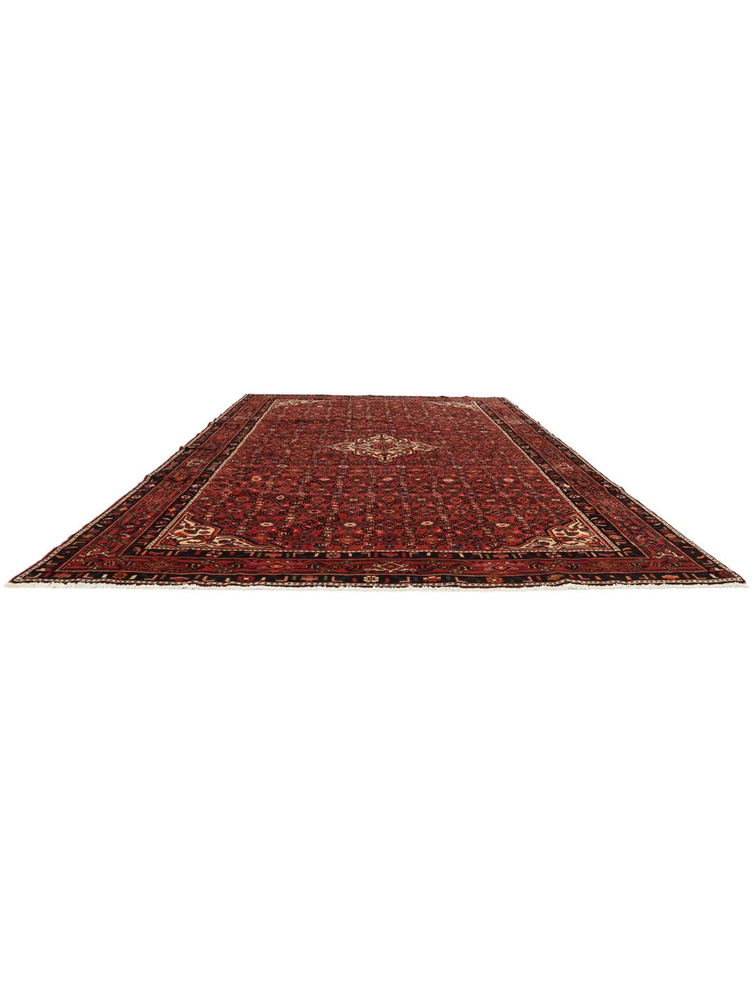 A hand-knotted Hosseinabad rug from the Middle East with a rich red field and central medallion.