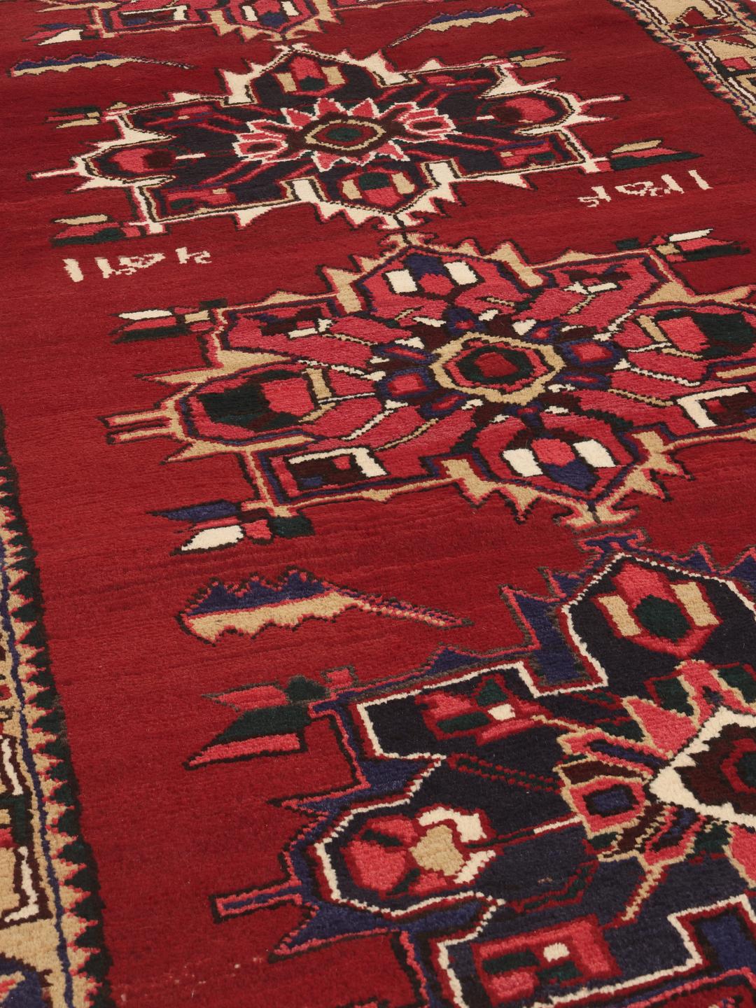 A hand-knotted Hamadan runner with traditional geometric red motifs