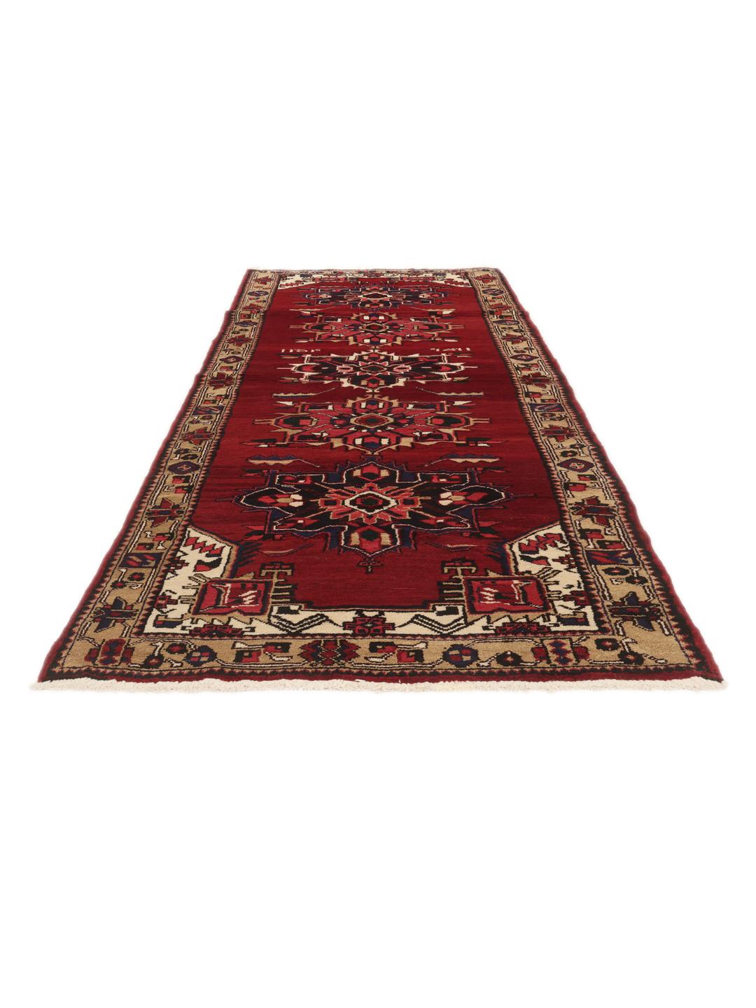 A hand-knotted Hamadan runner with traditional geometric red motifs