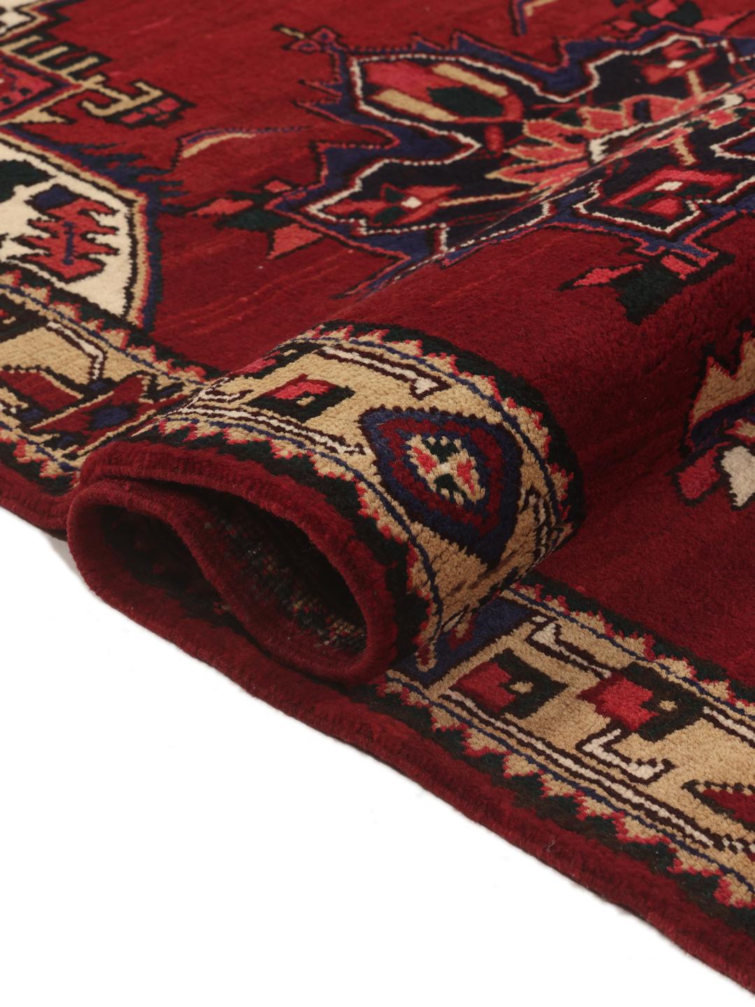 A hand-knotted Hamadan runner with traditional geometric red motifs
