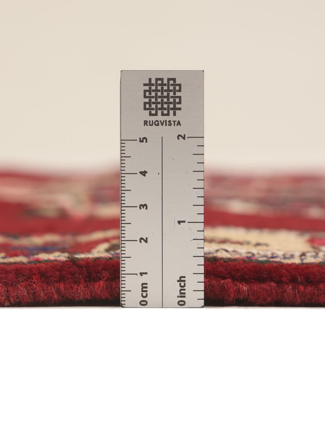 A hand-knotted Hamadan runner with traditional geometric red motifs