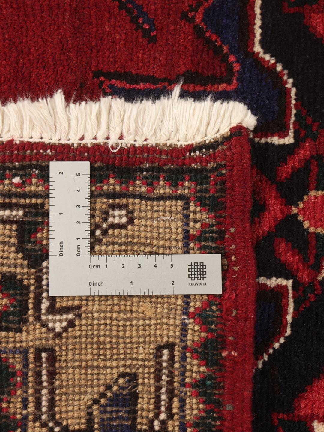 A hand-knotted Hamadan runner with traditional geometric red motifs