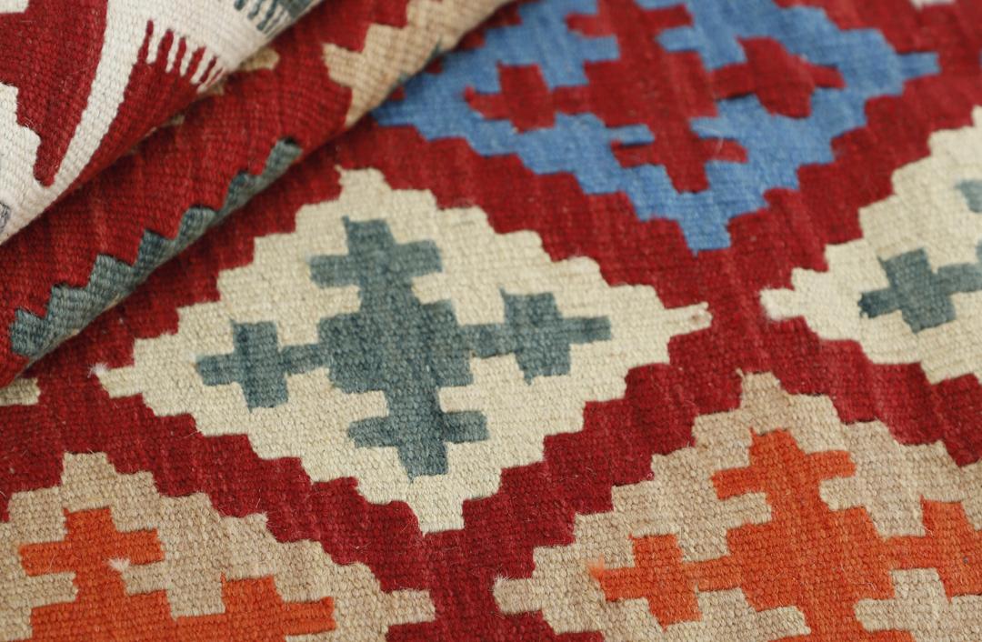 Hand woven Kilim rug from the Middle East in multicolor geometric patterns.