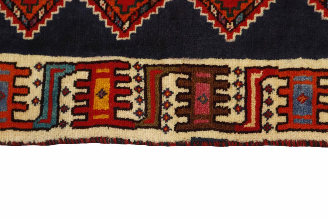 A red rectangular Qashqai rug with two brown lion motifs from the Middle East.