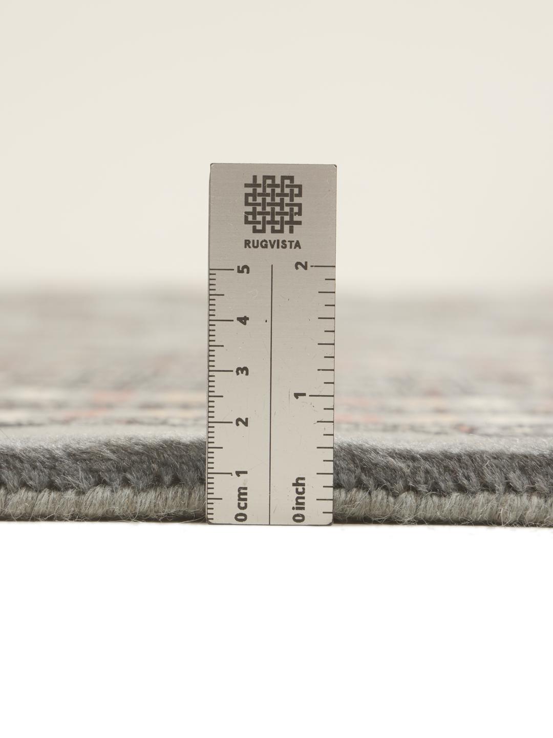 A hand-knotted Pakistan Bokhara rug in grey with traditional repeating motifs.