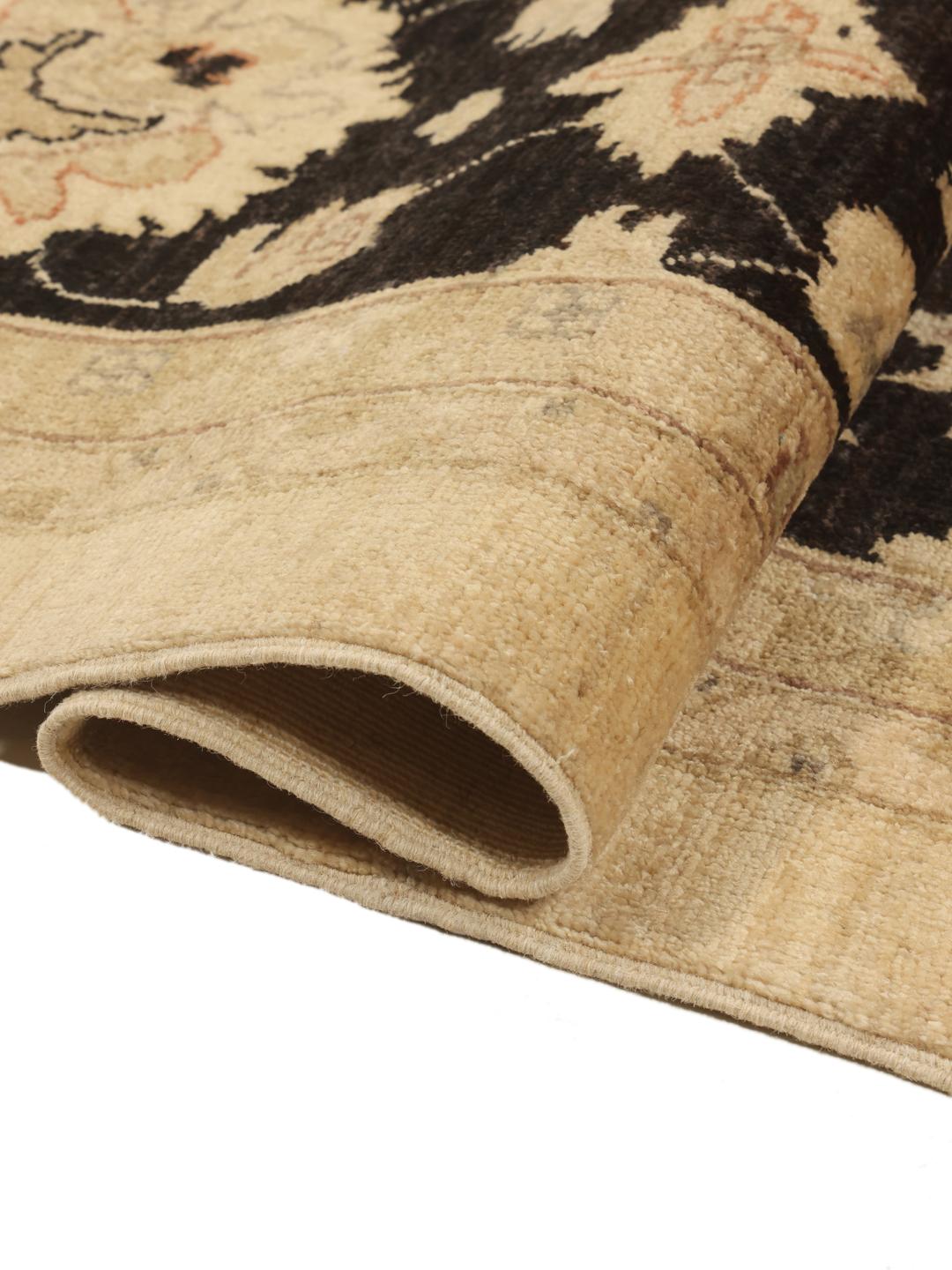 Handmade Ziegler rug from Afghanistan in beige and black with floral motifs