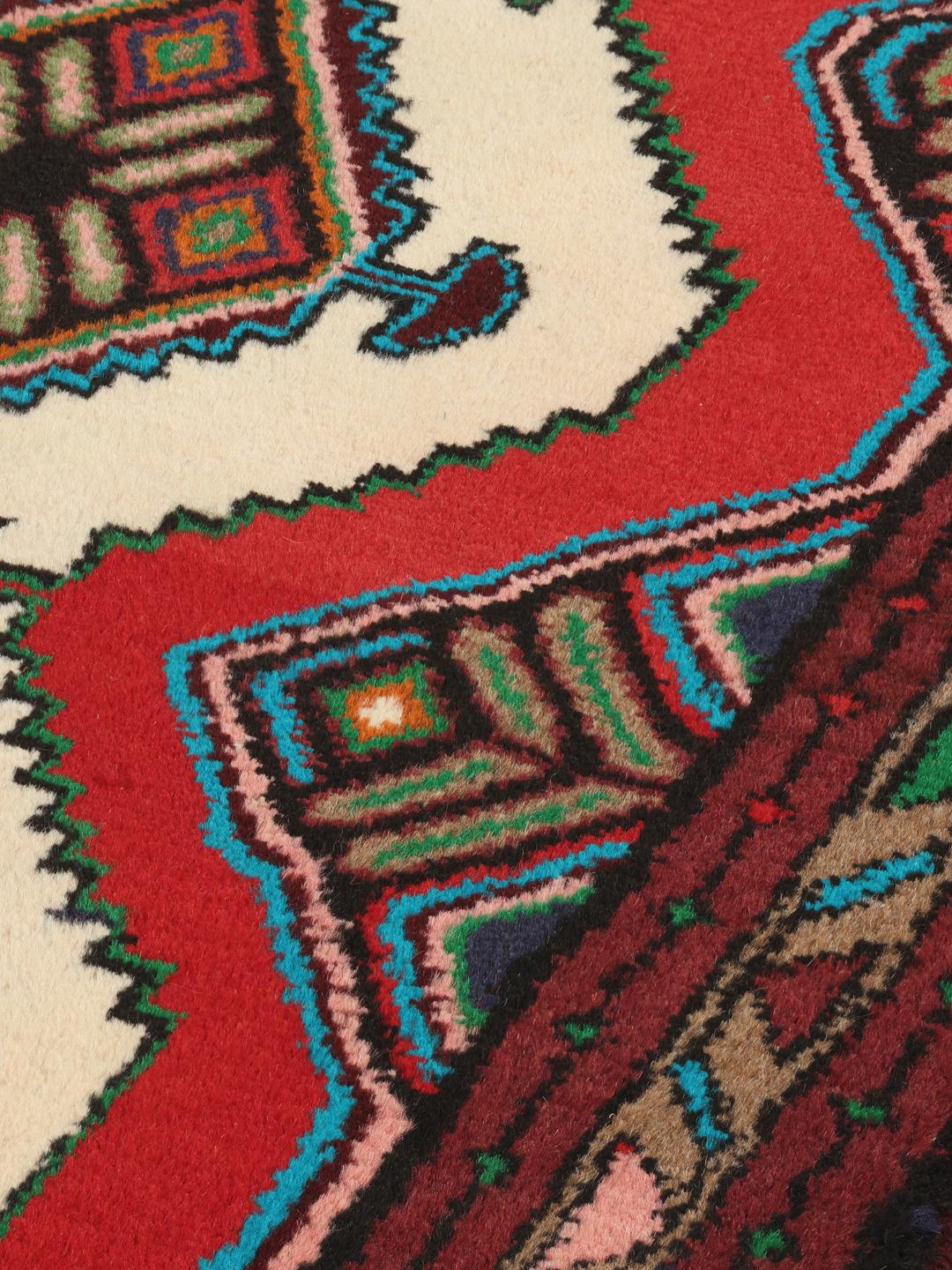 Hand-knotted Asadabad rug from the Middle East featuring a vibrant red, white, and multicolor geometric design.