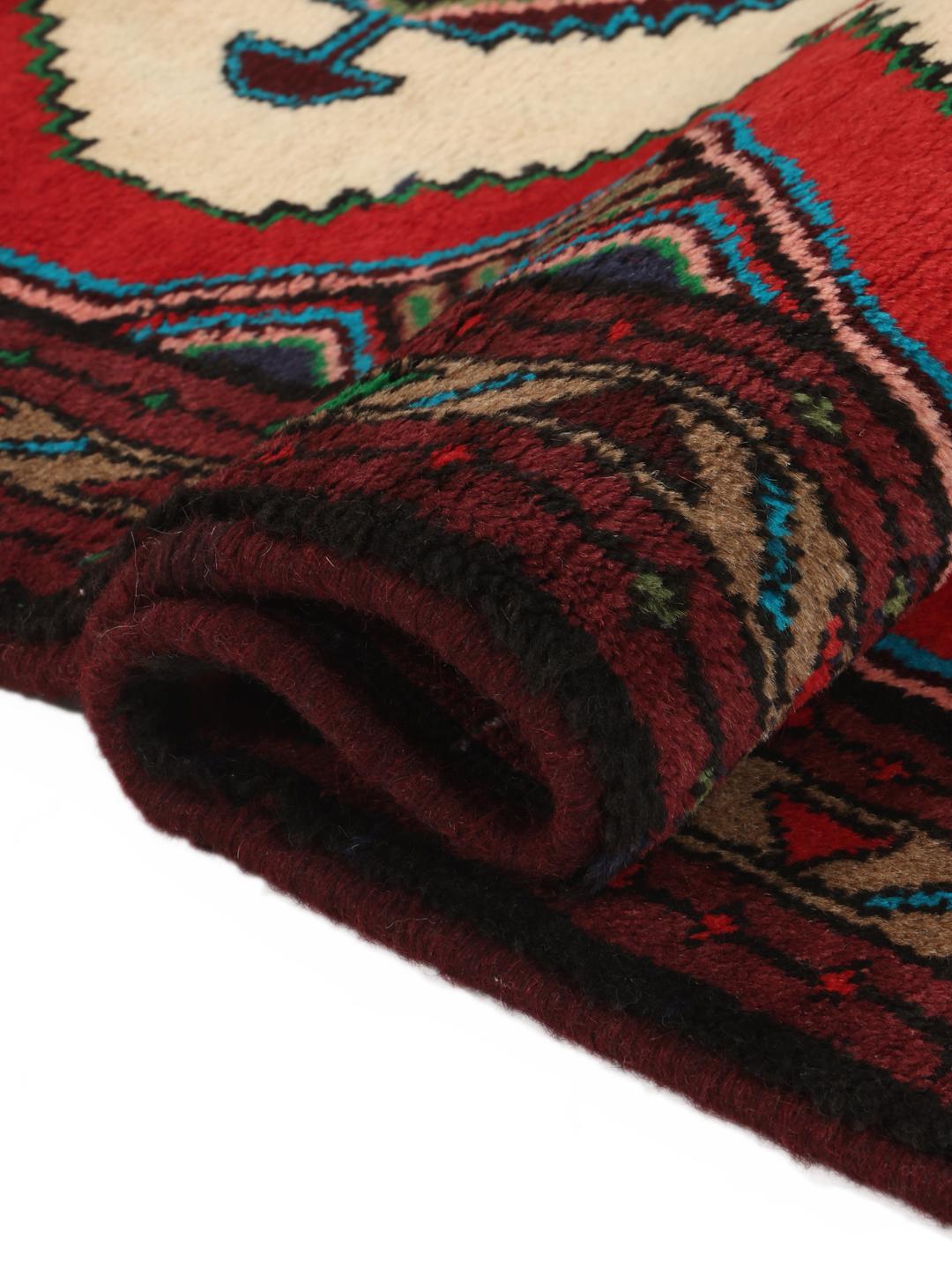 Hand-knotted Asadabad rug from the Middle East featuring a vibrant red, white, and multicolor geometric design.