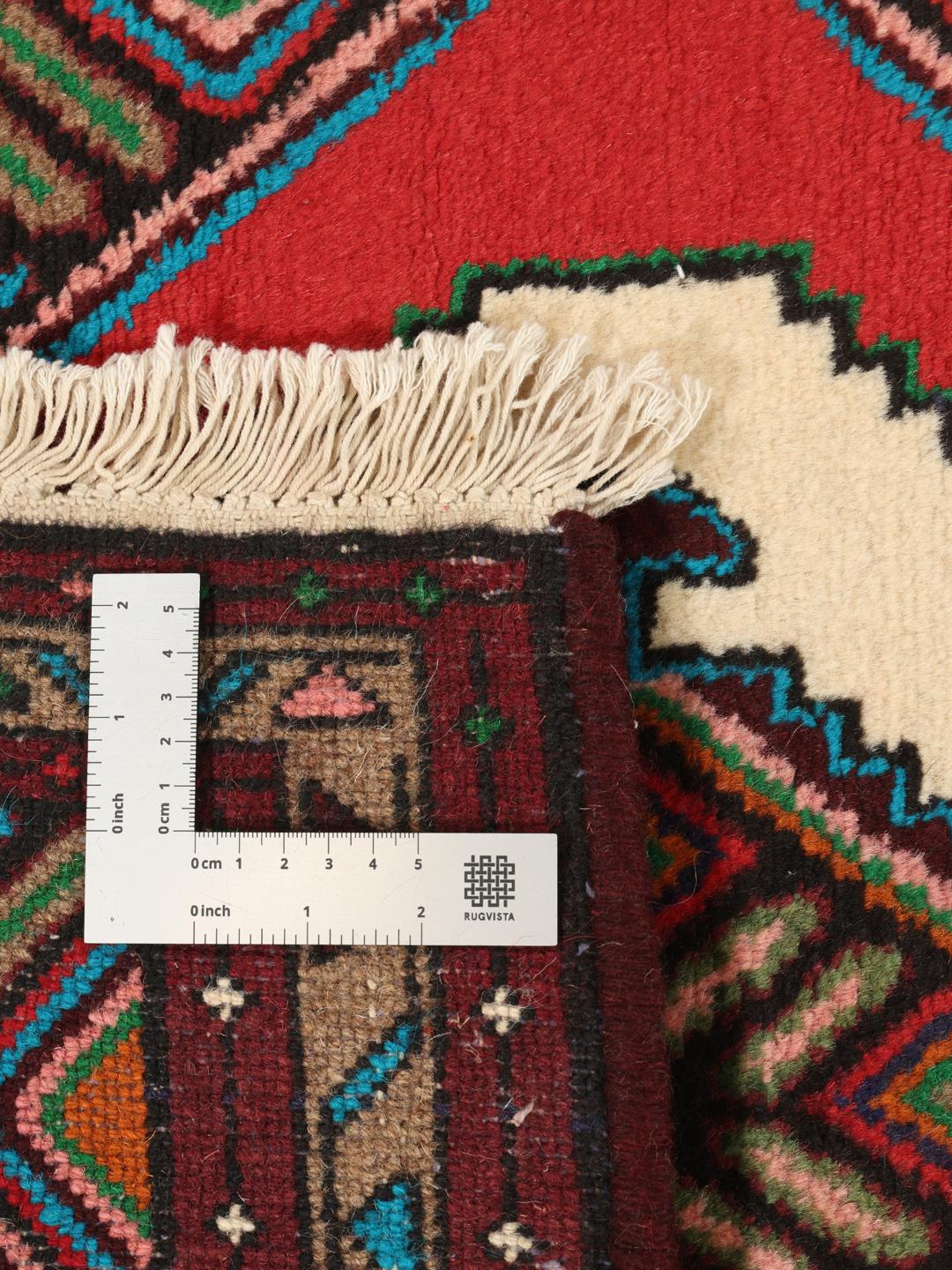 Hand-knotted Asadabad rug from the Middle East featuring a vibrant red, white, and multicolor geometric design.